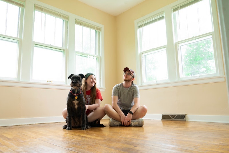 young couple on floor of new house housewarming gift
